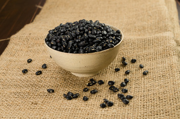 black bean in ceramic bowl on sack cloth