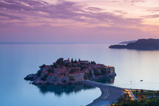 Elevated view over the picturesque island of Sveti Stephan illuminated at dusk, Sveti Stephan, Montenegro