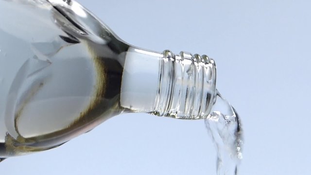 Pouring water out of a glass bottle