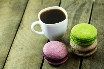 black coffee in a white cup and cookies