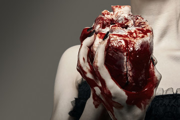 Fototapeta premium Young woman holding a human heart