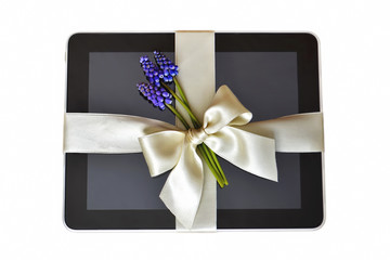 Digital tablet with white ribbon isolated on white background