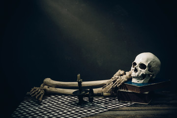 Human skull on old wood background ; still-life