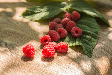 Ruspberry on the wooden background.