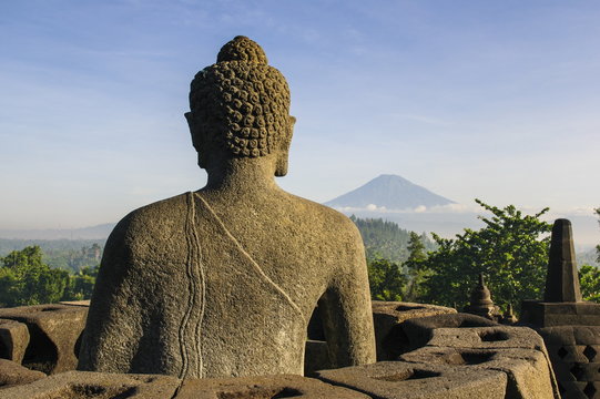 Sitting Buddha in the temple complex of Borobodur, Java, Indonesia