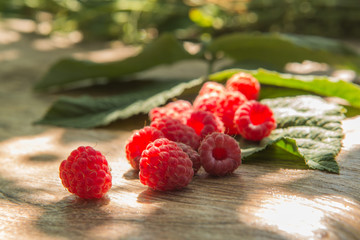Ruspberry on the wooden background.