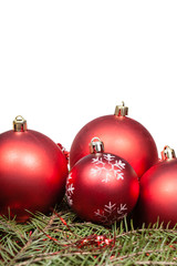 red Christmas balls on green fir tree branch