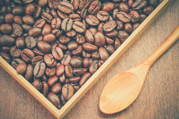 Coffee beans and wooden spoon with filter effect retro vintage s
