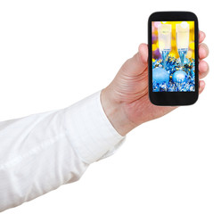 businessman holds handphone with Xmas still life