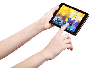 hand touches tablet pc with Xmas still life
