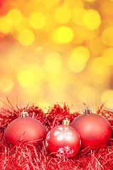 Xmas red balls on blurred yellow background