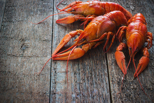 Boiled crayfish on a wooden background.