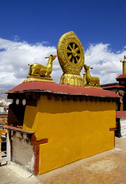 Golden Wheel of Dharma and deer sculptures on the sacred Jokhang Temple roof, Barkhor Square, Lhasa, Tibet, China 