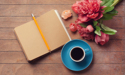 Cup of coffee with notebook
