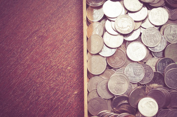 coins on wood with filter effect retro vintage style