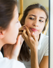 Girl squeezing pimple