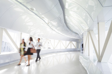 Business people walking in the office corridor.