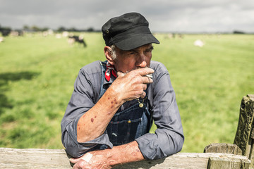Senior farmhand taking a smoke break