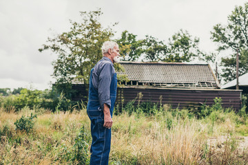 Senior Farmer Looking to the Distance at the Farm