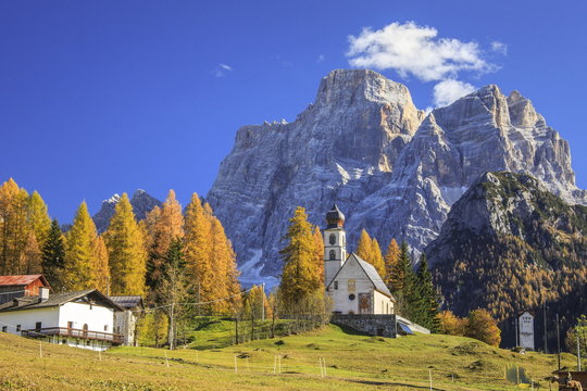 The tiny Church of Selva di Cadore, in the Dolomites, in autumn with the majestic Monte Pelmo in the background, Veneto