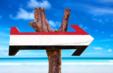 Yemen Flag wooden sign with coast background