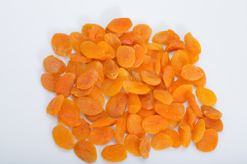 A heap of dried apricots on a white background
