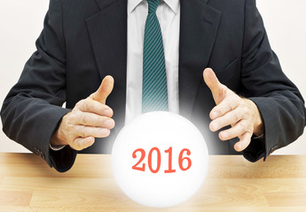 Fortune teller businessman predicting future new year 2016 with