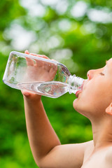 Young boy drinking water from bottle