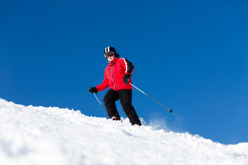 Fototapeta na wymiar Skier skiing on ski slope