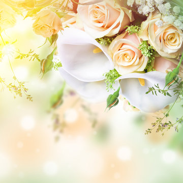 Bouquet for the bride of yellow roses and white calla lilies, floral background.