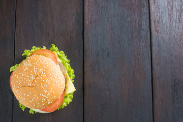 Delicious homemade hamburger on wooden desk, shot from upper view