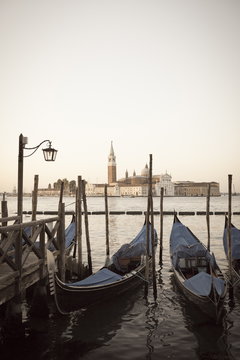 Gondolas moored on the Lagoon, San Giorgio Maggiore beyond, Riva degli Schiavoni, Venice, Veneto