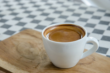 Esspresso coffee in a white cup on the table.