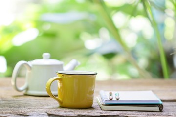 Notebook and tea on wooden table