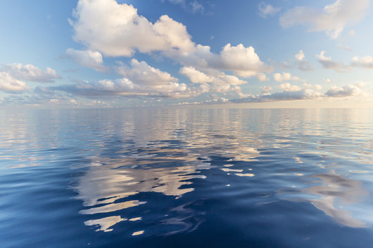Reflected clouds in calm seas near the island of Deserta Grande, in the Ilhas Desertas, near Funchal, Madeira, Portugal, Atlantic