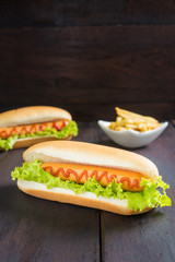 Hot dog with french fries on wooden table