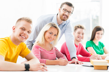 Group of teenage students studying at the lesson in the classroom