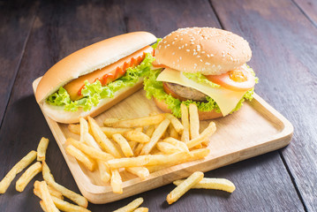 hamburger, hot dog, french fries on the wooden background