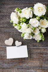 White roses and wooden hearts