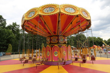 Orange carousel in an empty amusement park in late summer