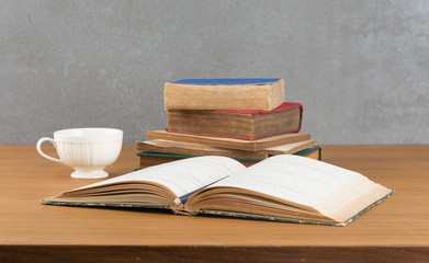 old book with pencil and coffee