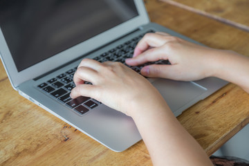 Fototapeta premium Closeup of business woman hand typing on laptop keyboard