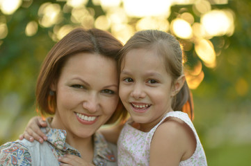 Fototapeta na wymiar Little girl with mother in park