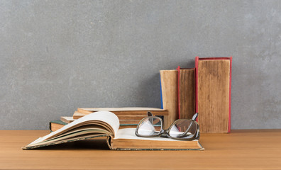 stack of books with glasses