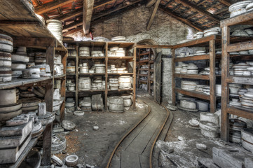 Shelves of clay moulds at an abandoned ceramics factory