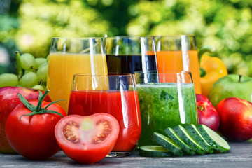 Glasses with fresh organic detox juices in the garden