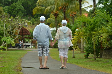 Elderly couple in tropical garden