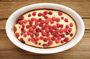 Homemade yummy sponge cake with wild raspberries in white oval b