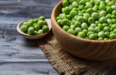 Green peas in wooden bowl