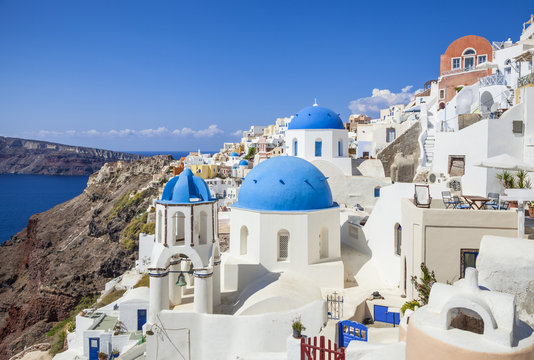 Greek church with three blue domes in the village of Oia, Santorini (Thira), Cyclades Islands, Greek Islands, Greece